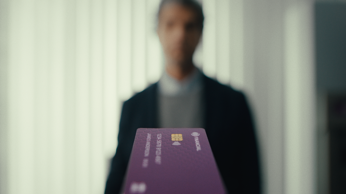 A stylized depth-of-field composition introduces the final credit card reveal, symbolizing trust through premium cinematography.