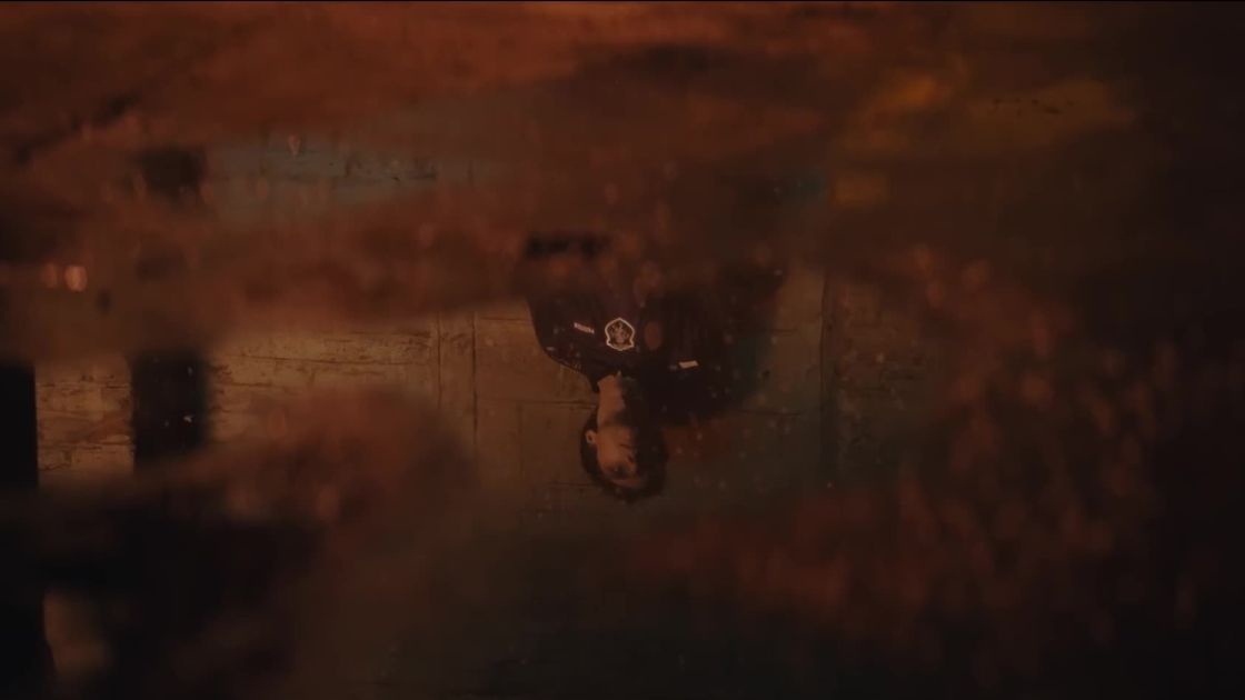 A moody, cinematic shot capturing a player’s reflection in a pool of water. The distorted surface adds a surreal layer, setting the tone for tension and introspection.