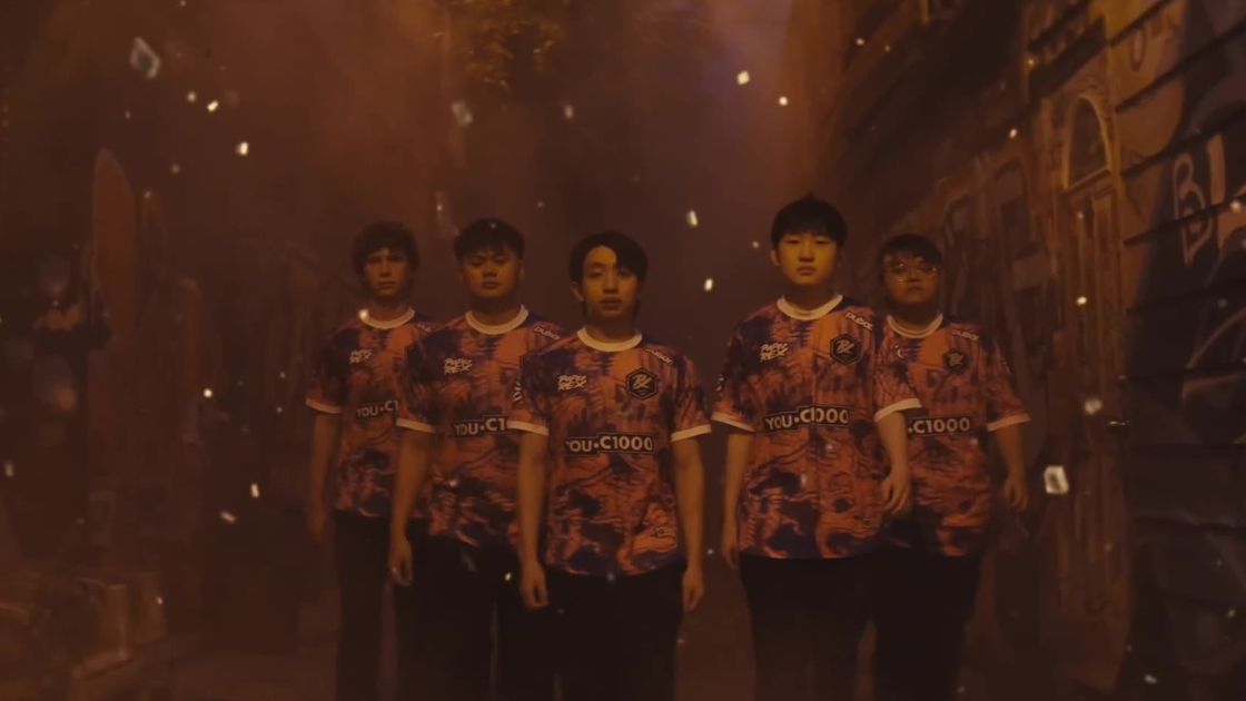 A team strides down a graffiti-covered alley as embers fall through the air. Their vibrant jerseys and determined expressions create a striking visual against the orange-hued haze.