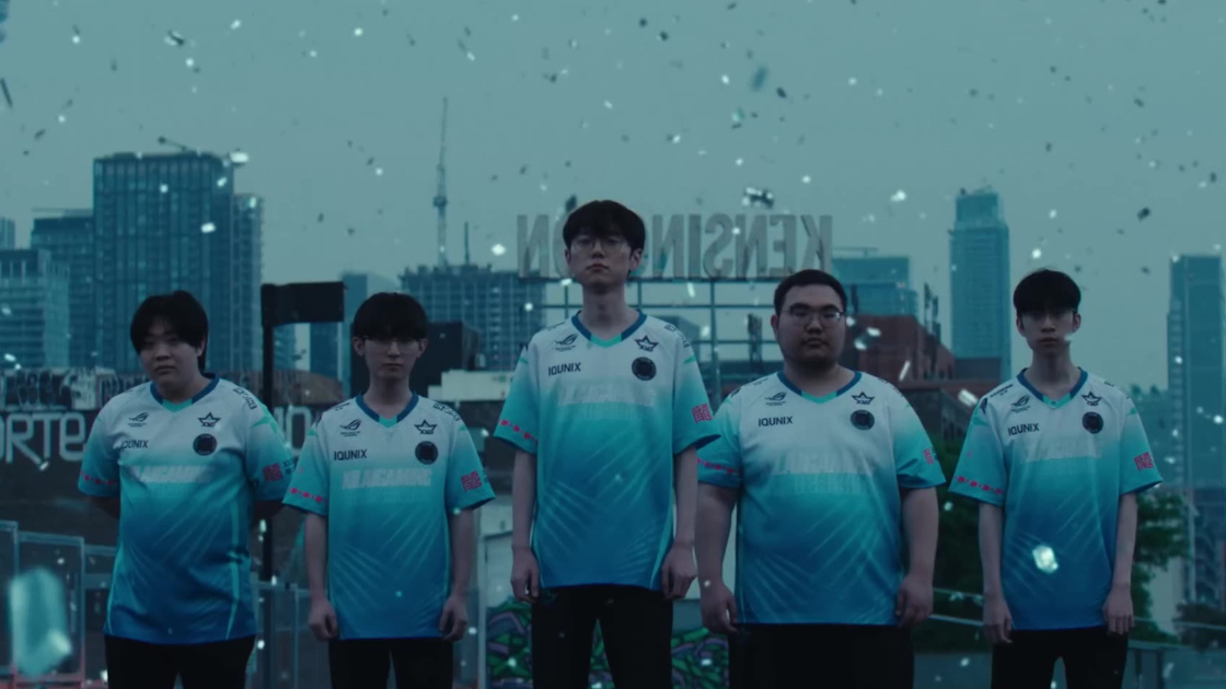 A lineup of players in icy blue jerseys stands on a Toronto rooftop, framed by city skyline and snow-like digital flakes. The shot feels still and commanding — ready for battle.